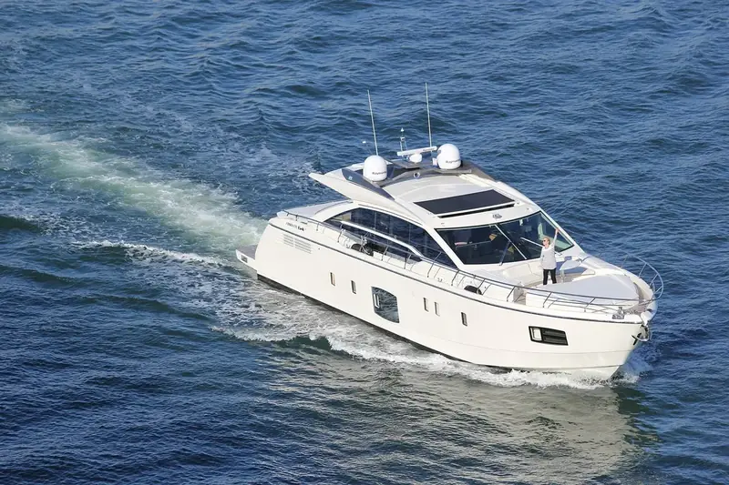 White motor yacht cruising on blue water